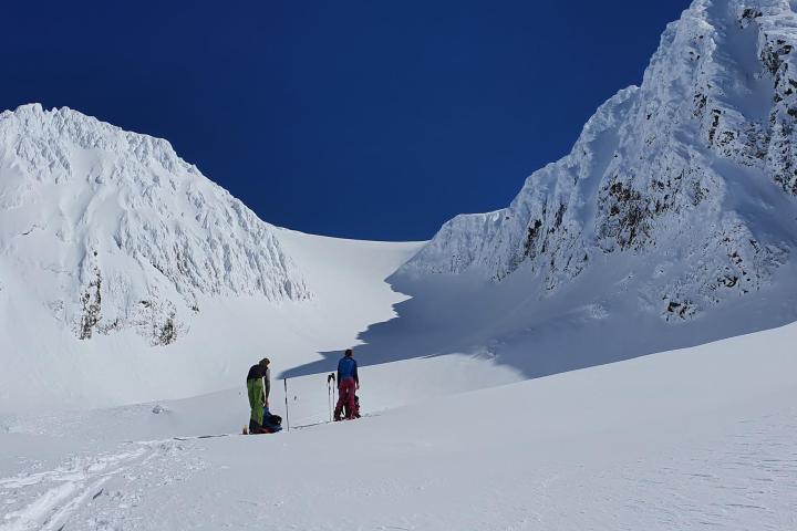 a man skiing down the side of a snow covered mountain