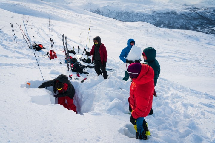 a couple of people that are skiing in the snow