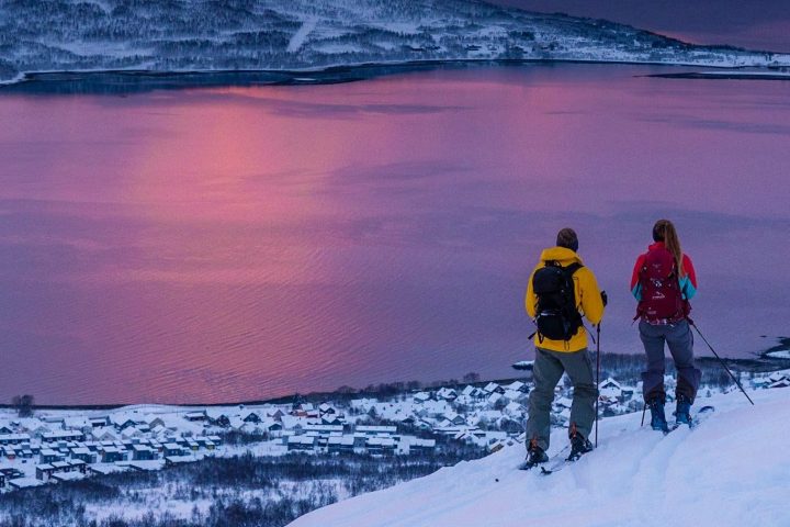 a man standing on top of a snow covered mountain